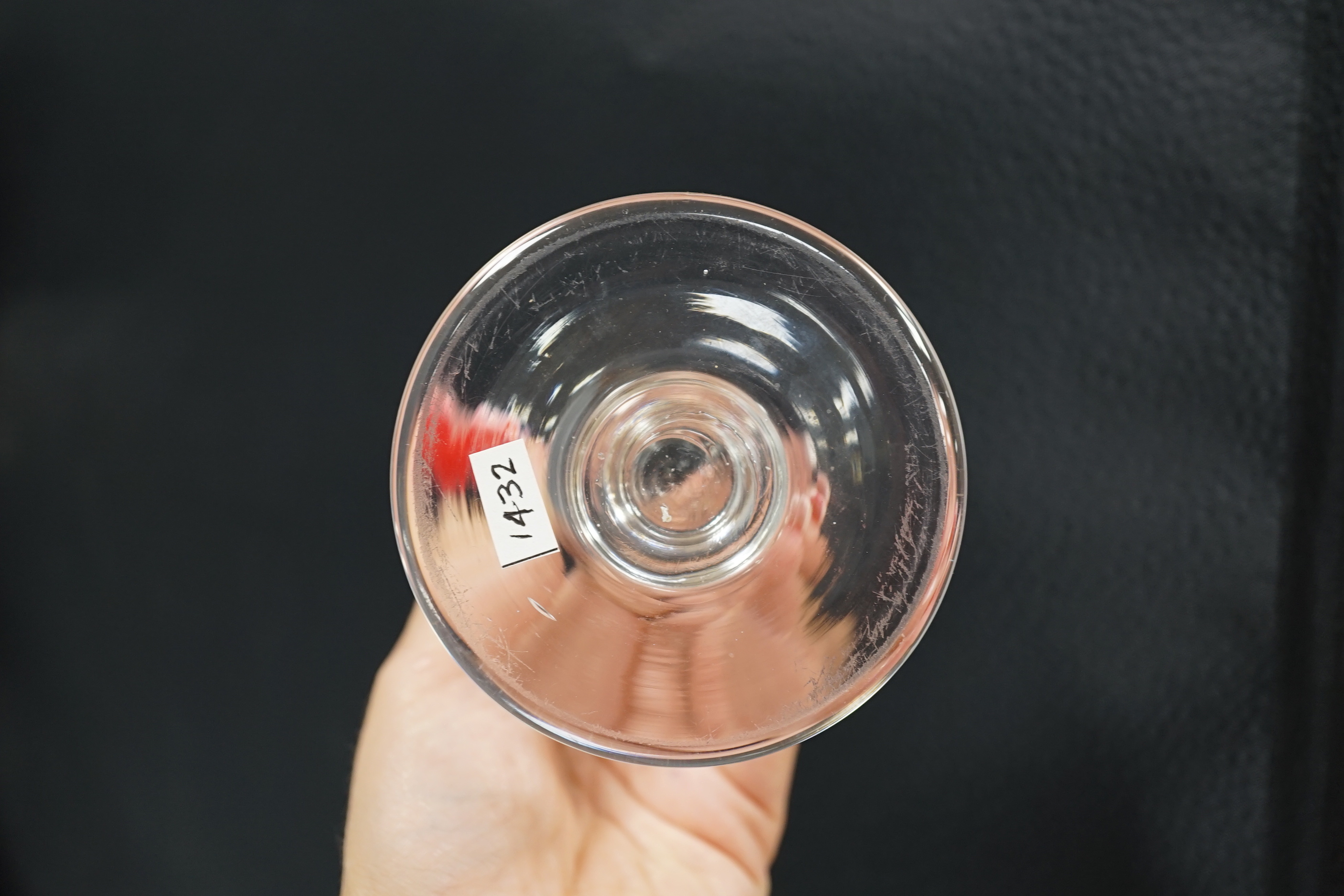 An English lead crystal ships’ dram, c1790-1800, the bowl, which is heavily striated, is of rounded funnel form on a capstan stem, with a very wide and heavy firing foot, 9.9cm high